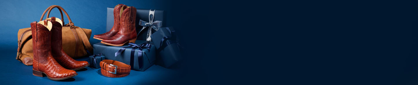 Three single boots from the Limited Edition Collection sitting on a pile of navy-wrapped gifts.
